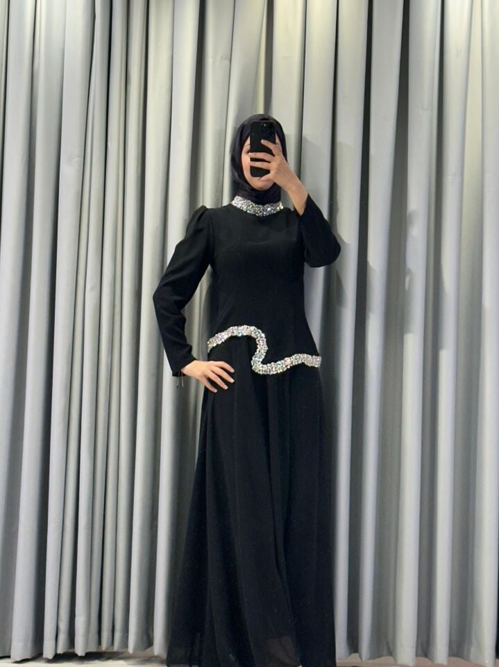 Yüksek yaka ve bel/göğüs altı kısmında parlak taş/pul işlemeler gümüşi/beyaz tonlarda) bulunmaktadır Şık  Siyah  Abiye Elbise 44