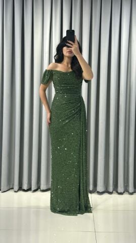 Baştan sona pullu ve payetli, parlak bir görünüme sahip Omuzları açık (kayık yaka veya düşük omuz) bir kesime sahip Bel ve kalça hizasında drapeli yüksek yırtmaç detaylı abiye 48 - YEŞİL