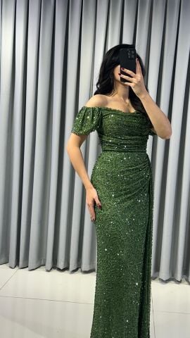 Baştan sona pullu ve payetli, parlak bir görünüme sahip Omuzları açık (kayık yaka veya düşük omuz) bir kesime sahip Bel ve kalça hizasında drapeli yüksek yırtmaç detaylı abiye 42