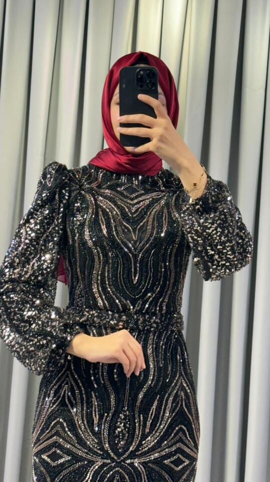 Pullu ve payetli Vücuda oturan, balık kesim Parlak, gümüş-siyah tonlarında yoğun pul ve payet işlemeleri bulunur Omuzları hafif kabarık Siyah Abiye